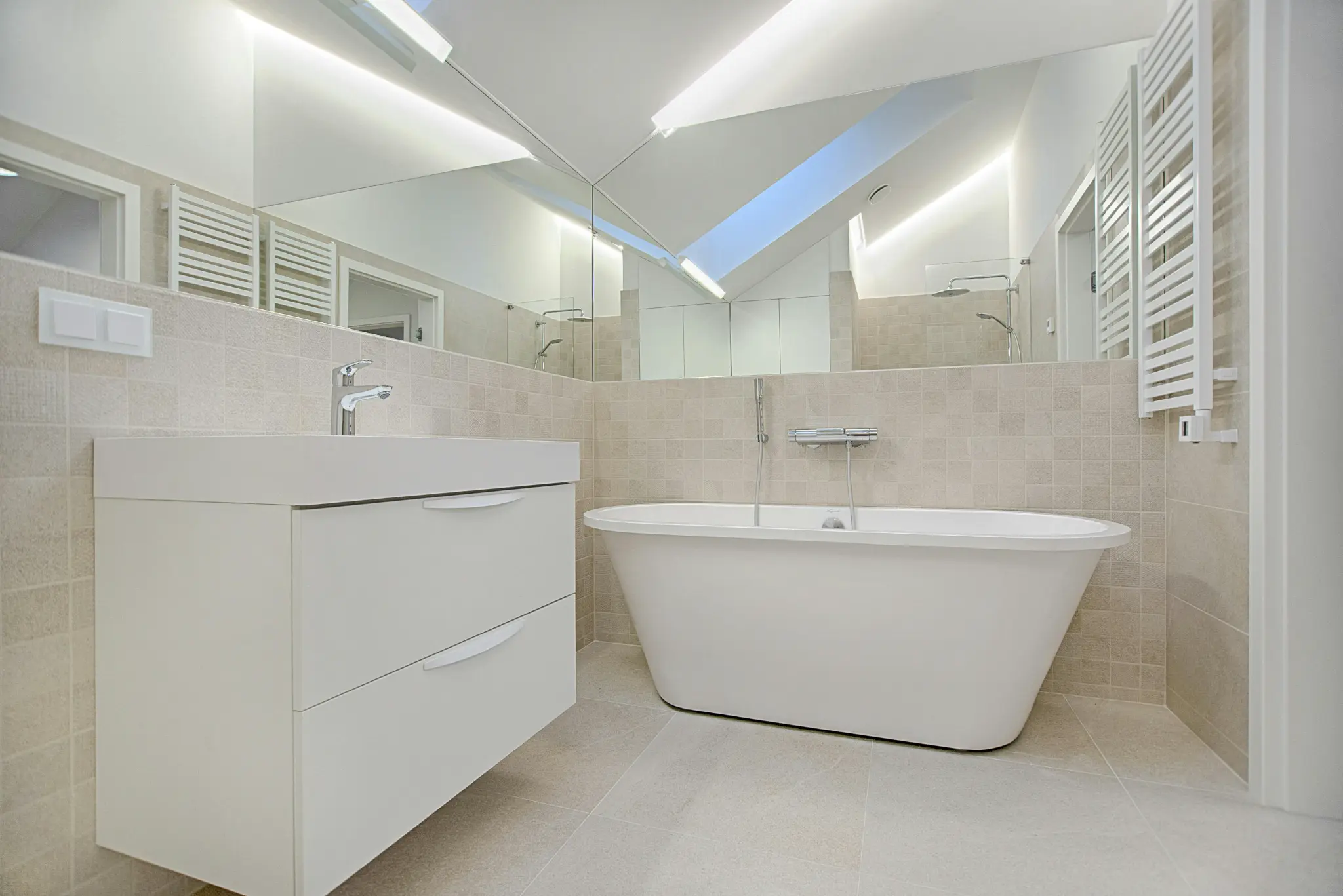 A sleek, modern bathroom features a white vanity and freestanding tub. Consider spray paint bathroom fixtures for a refreshed look.