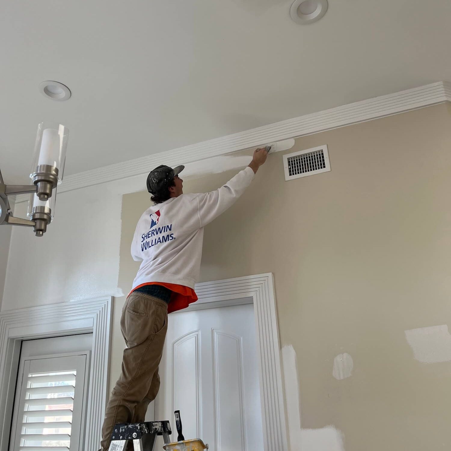 Pro-Vision painter cutting a clean line on an interior wall in Jacksonville Beach