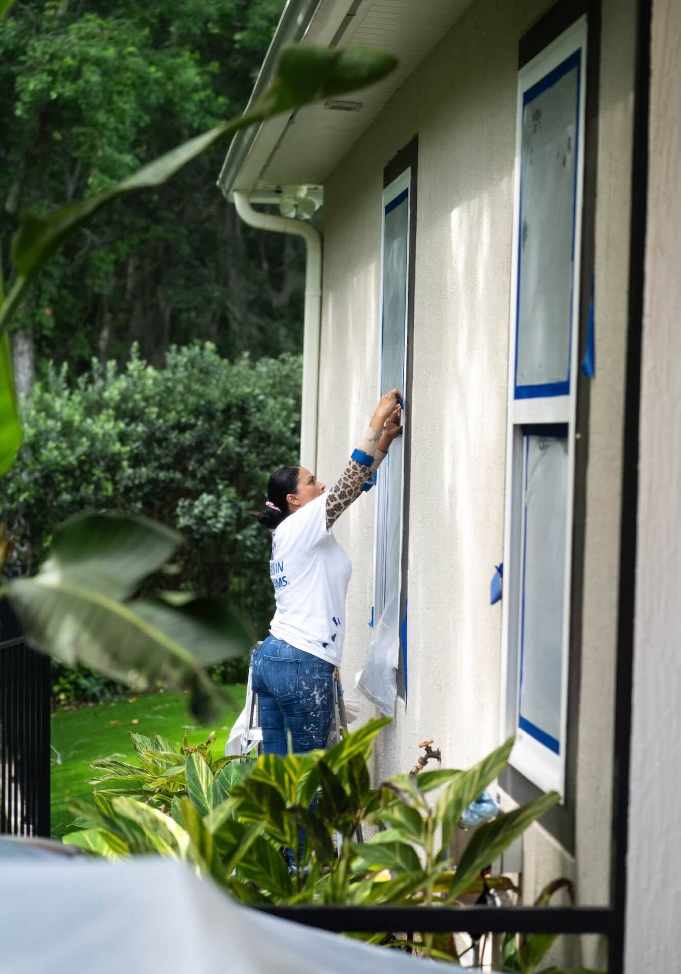pro-vision painting team member prepping home exterior for a paint job