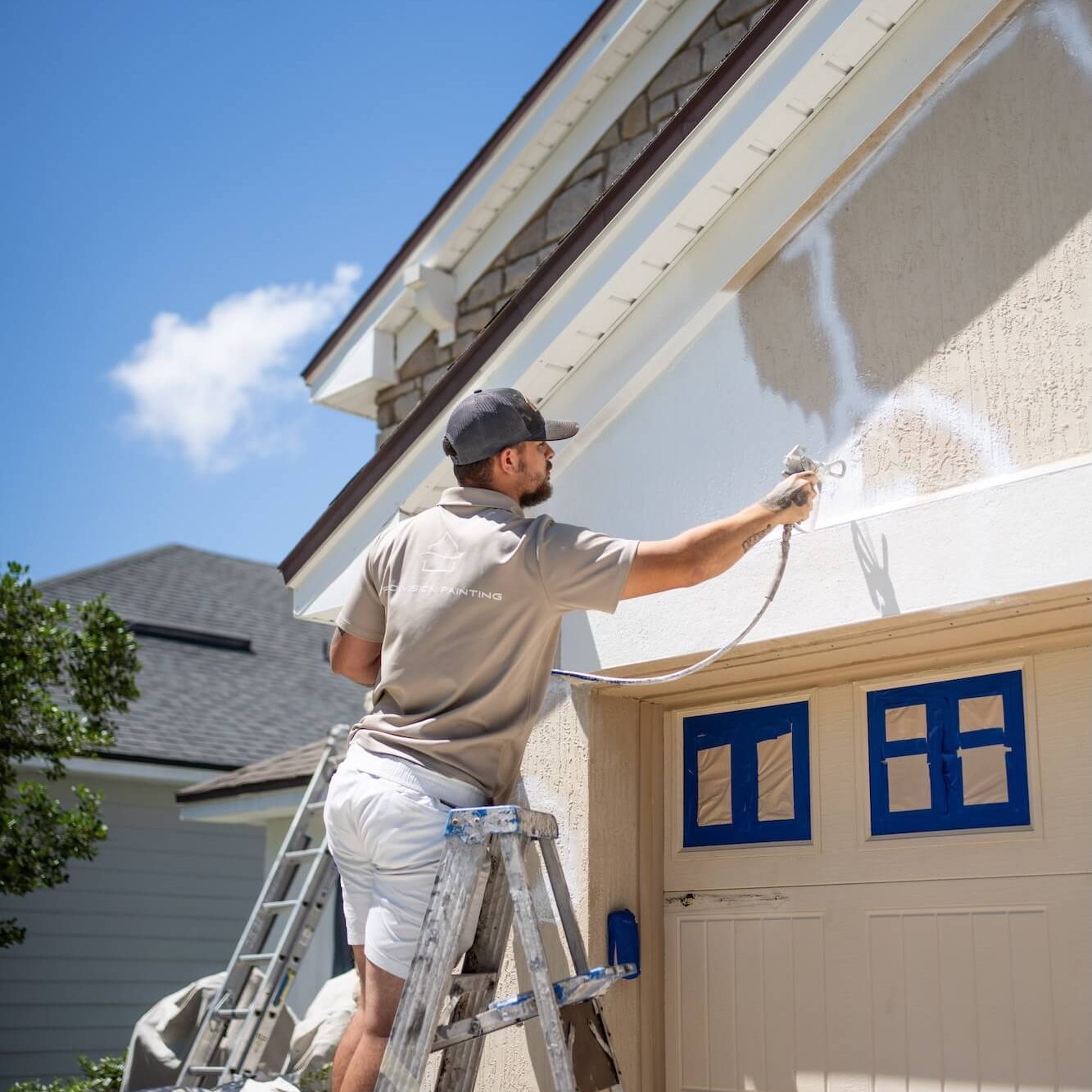 pro-vision painting team member patching and repairing stucco exterior on home in jacksonville beach
